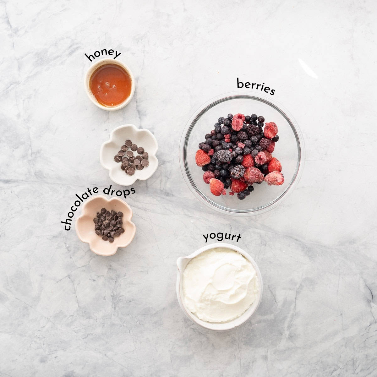 Ingredients for Halloween yogurt bark with text overlay on benchtop.