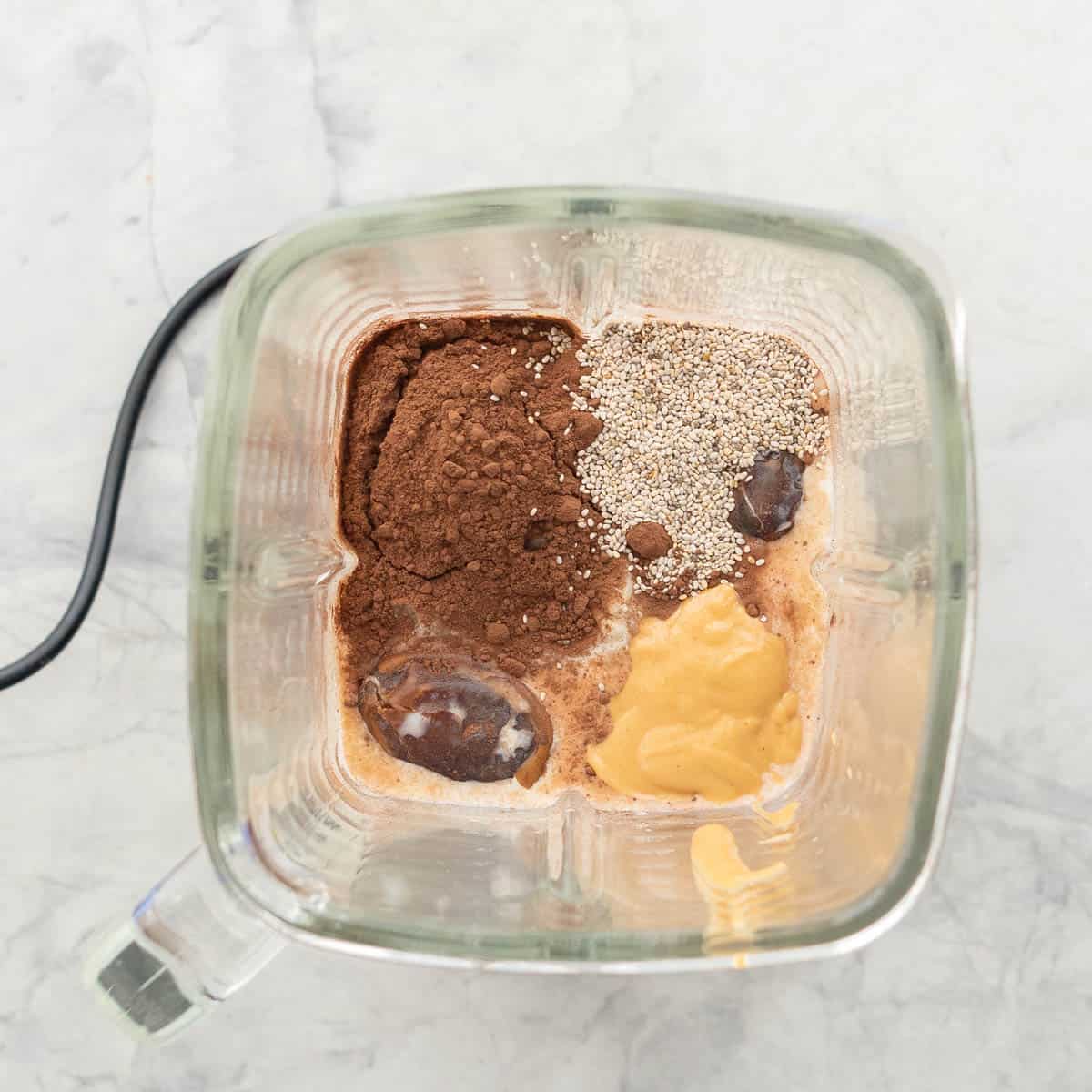 Ingredients for Chocolate for peanut butter smoothie placed in a blender.