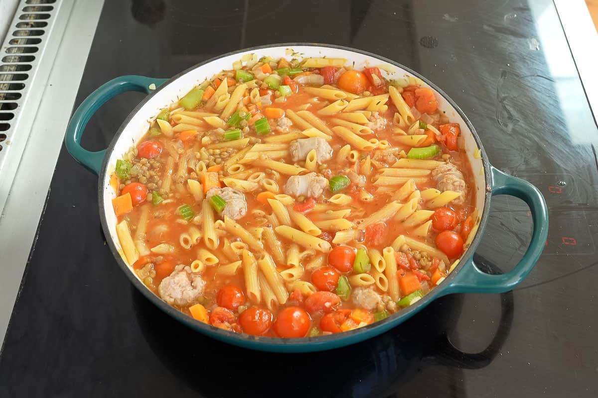 Pasta added into pan to cook.