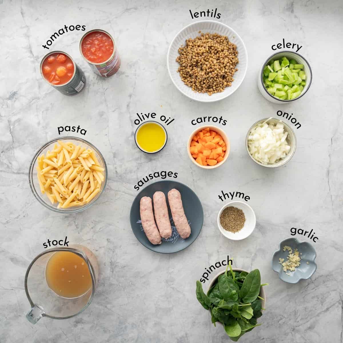 Ingredients for Sausage Pasta on benchtop with text overlay.