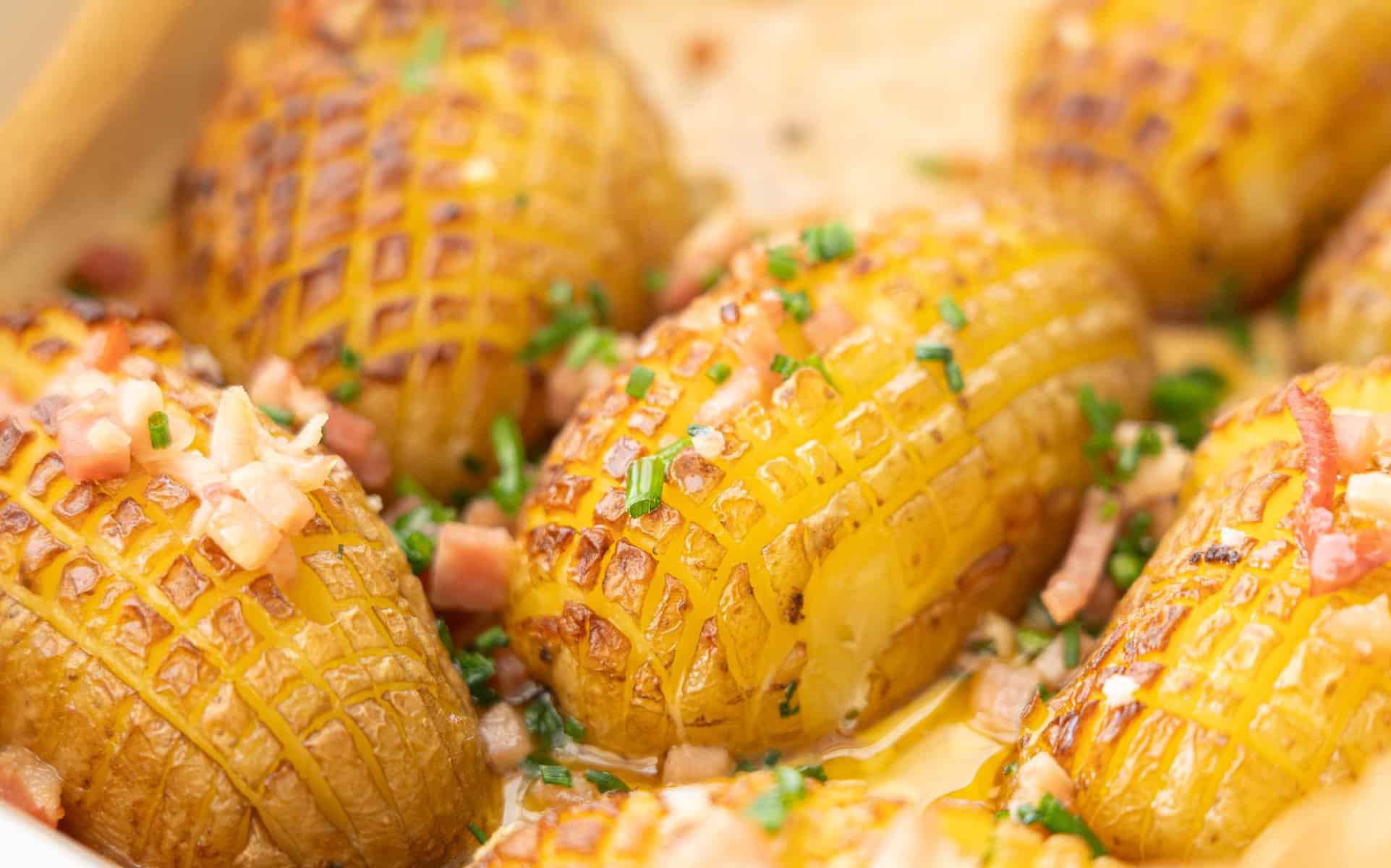 Baked Christmas potatoes with chives and bacon garnished on top.