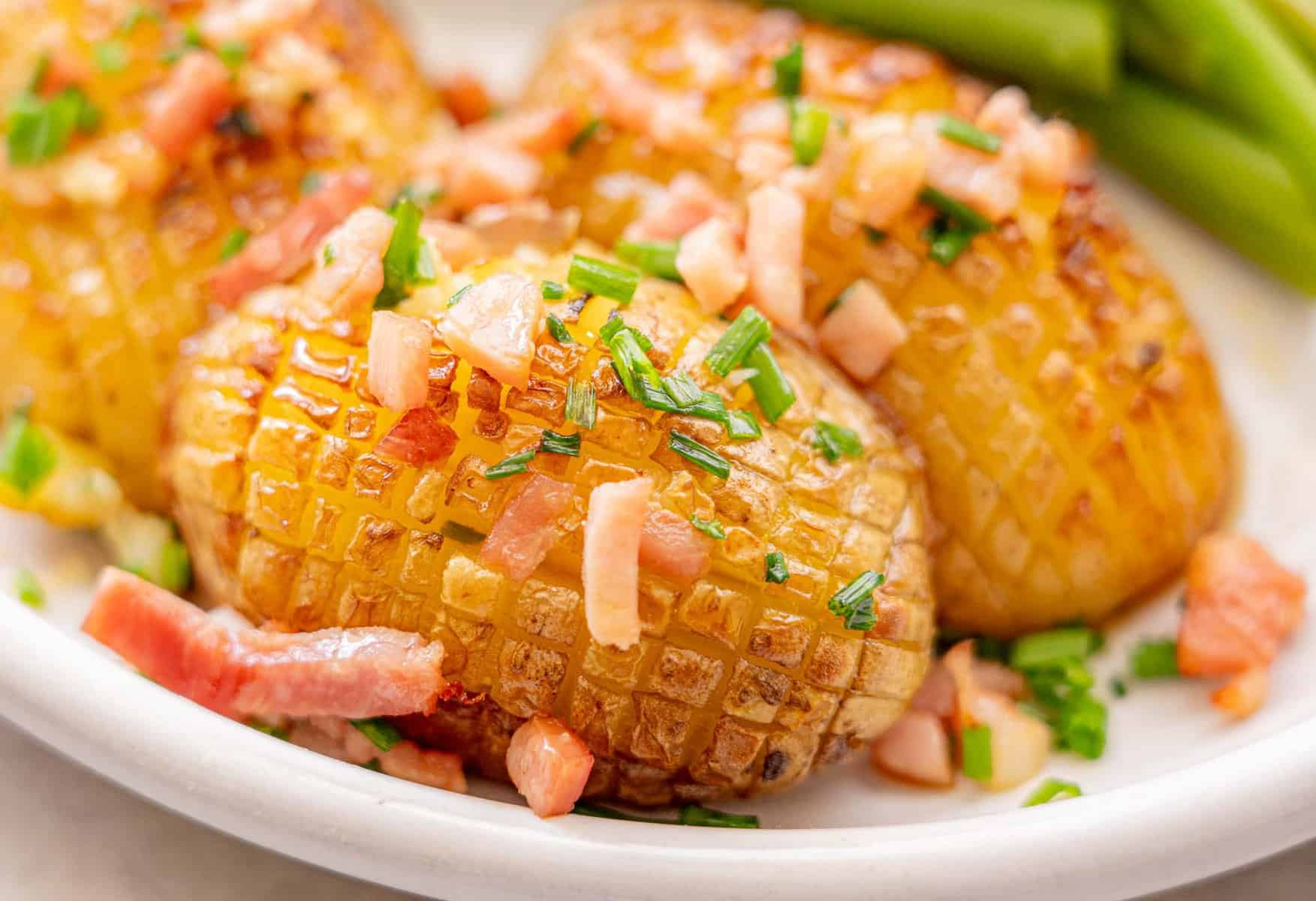 Baked Christmas potatoes with chives and bacon garnished on top.