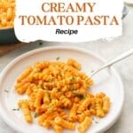 A plate of creamy tomato pasta, garnished with parsley flakes, with text overlay: Quick and Easy Creamy Tomato Pasta Recipe.