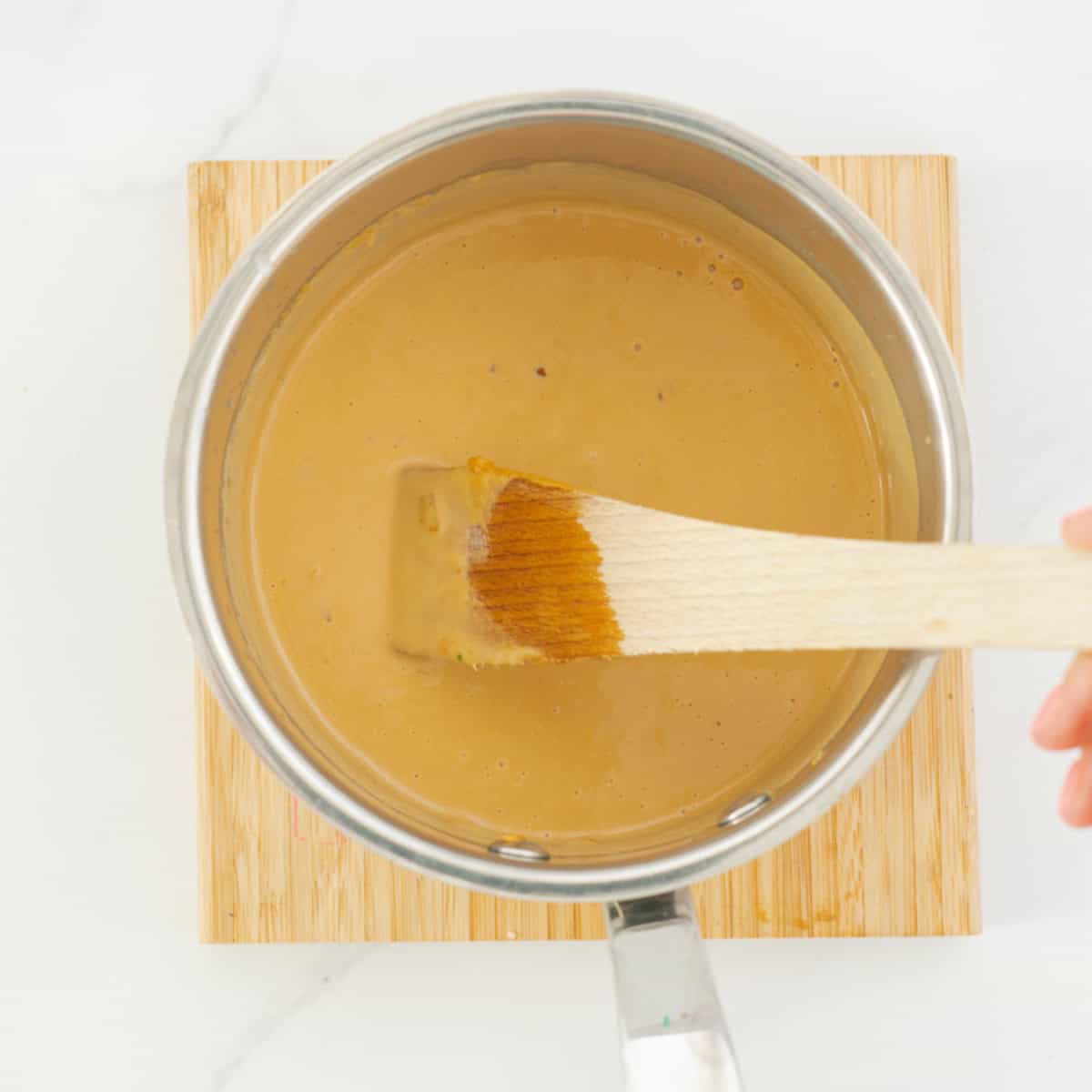 Smooth peanut sauce in a saucepan. 