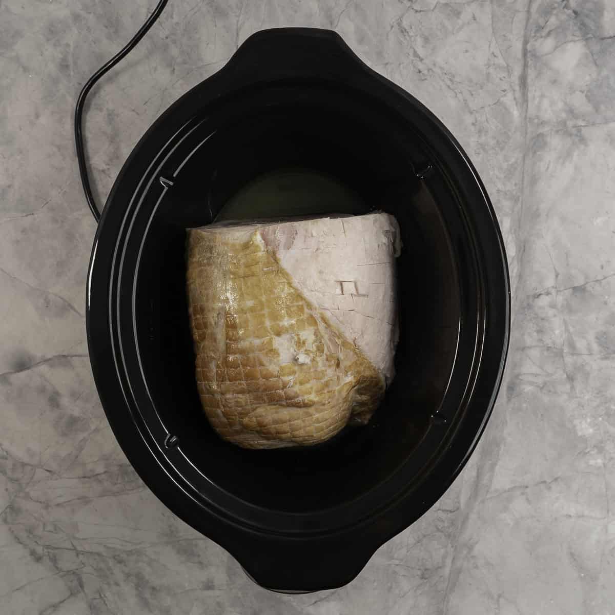 A ham inside a crockpot.