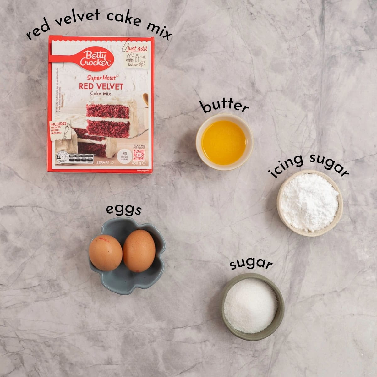 Ingredients for red velvet cake crinkle cookies on a marble benchtop with text overlay.