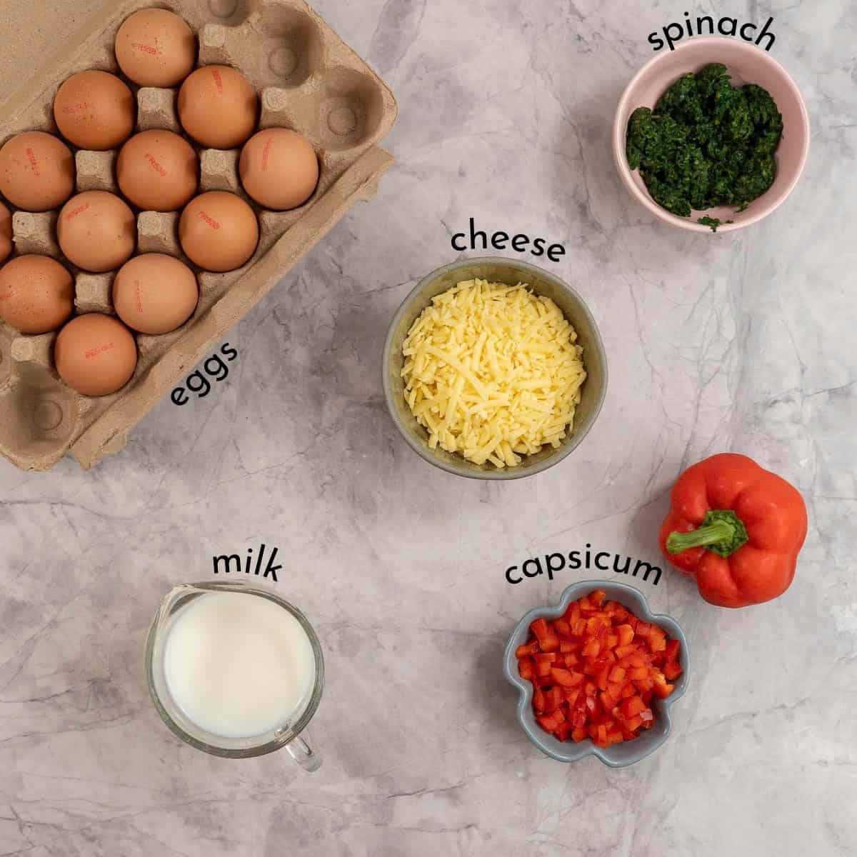 Ingredients for sheet pan eggs on benchtop with txt overlay.